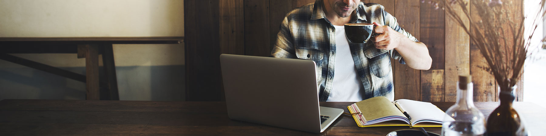 Man working on laptop in Coffee Shop