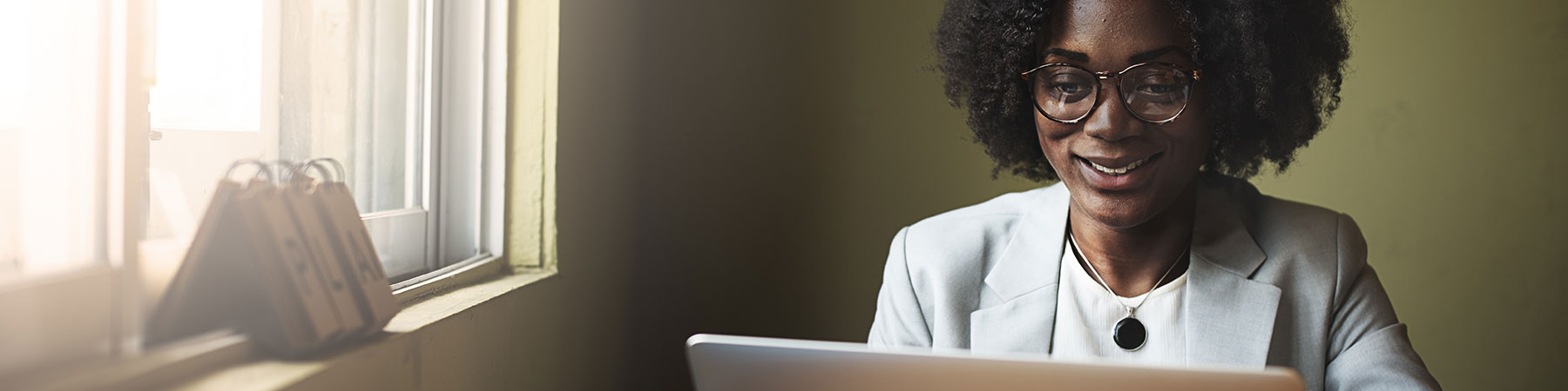 Smiling woman using laptop