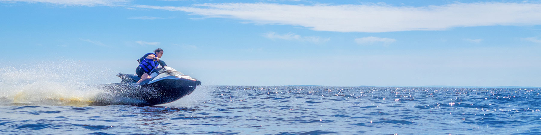 Woman riding jet ski on lake in summer