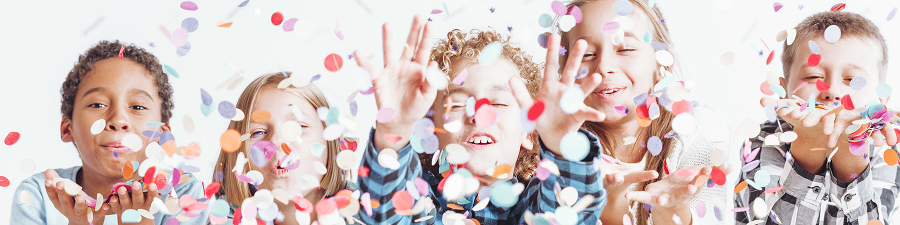 Group of children throwing confetti